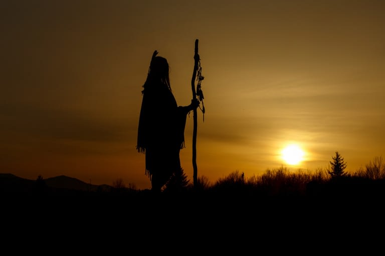 silhouette of native american shaman with pikestaff