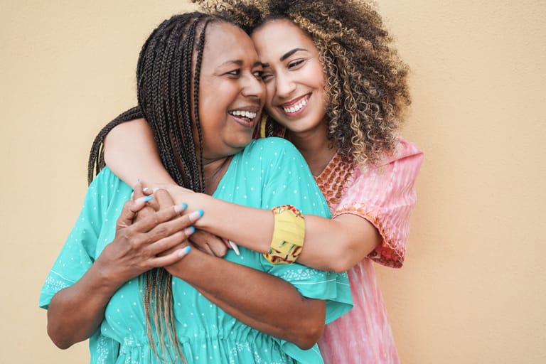 Happy mother and daughter hugging each others - Love and family concept