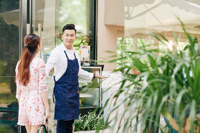 Waiter opening door for client