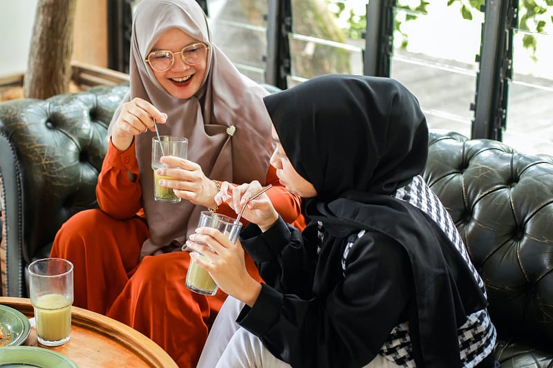 Muslim friends talking at cafe