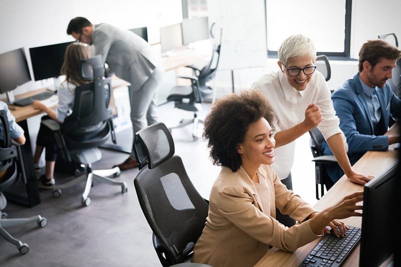 Group of young business people working and communicating at the office